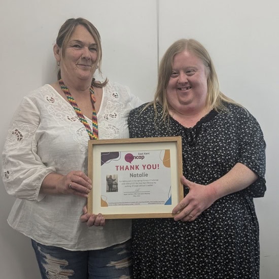 Natalie receiving her certificate from Senior Support Worker, Maria