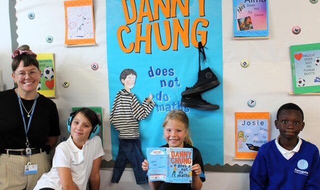 RAPSliteracy - English lead Claire O'Flaherty and children with one of the many colourful corridor displays